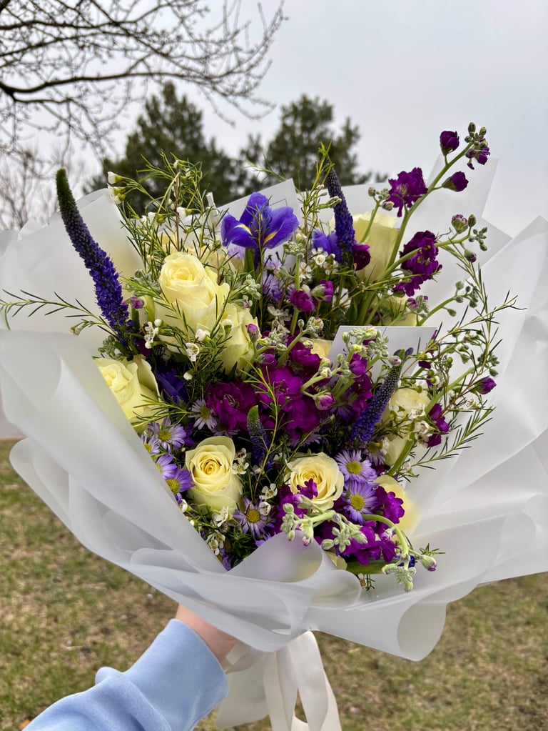 Purple and white flowers in white floral paper