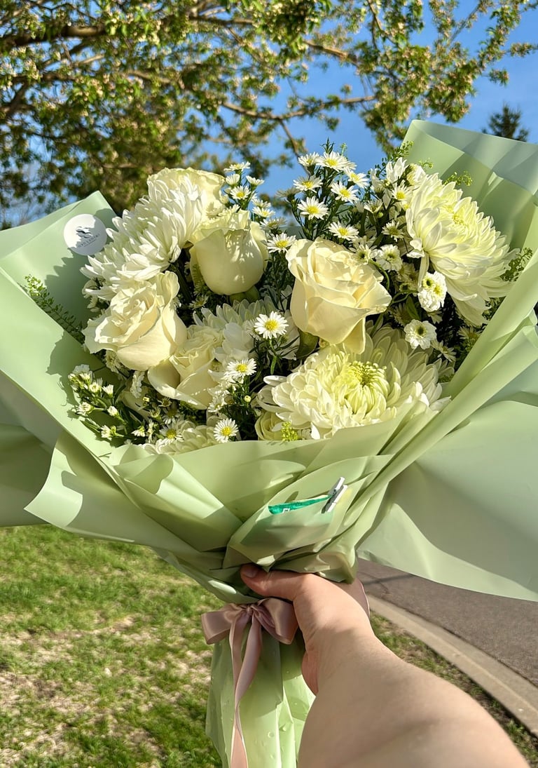 White roses and chrysanthemums in pale green paper