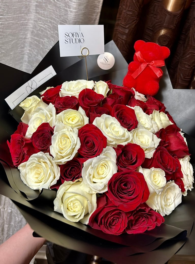 Luxury red and white roses in black paper with teddy bear