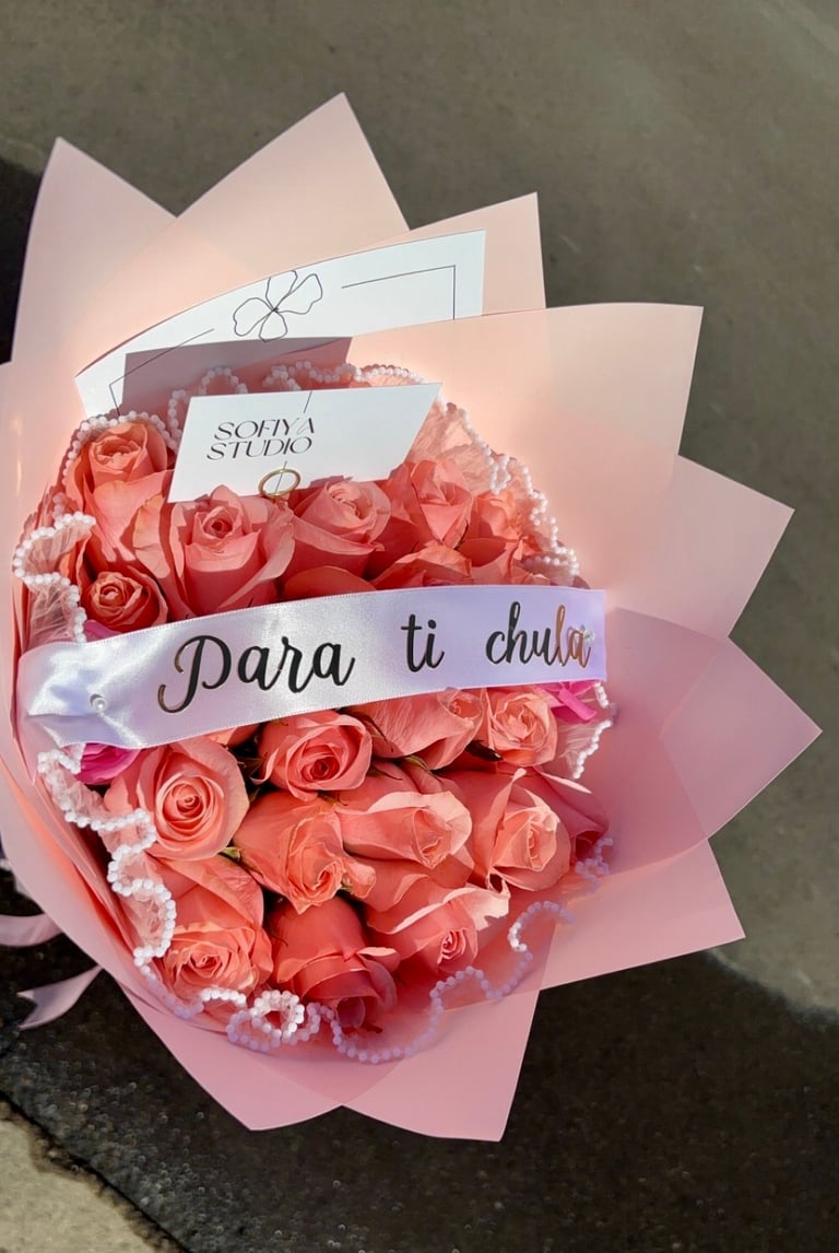 Pink roses in floral wrap with white ribbon Para ti chula